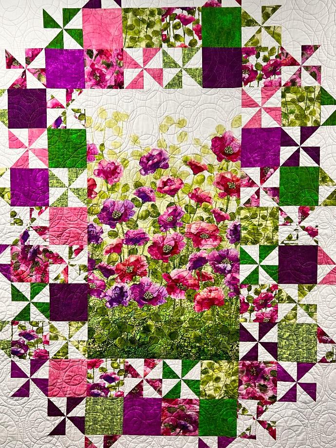 Freespirit Fabric Quilt, featuring purple flowers and pinwheel blocks